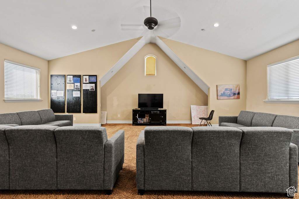 Carpeted living area with a ceiling fan, recessed lighting, and vaulted ceiling