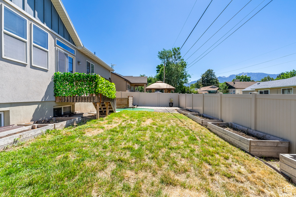 View of yard with a vegetable garden and a mountain view
