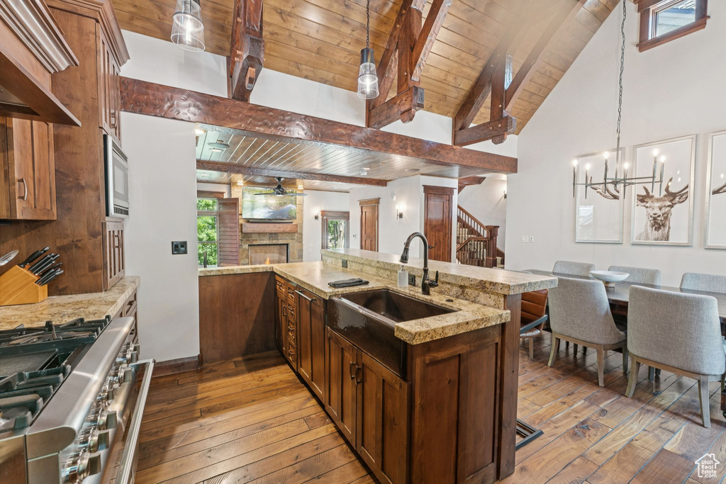 Kitchen with stainless steel appliances, wooden ceiling, light wood finished floors, open floor plan, and ceiling fan