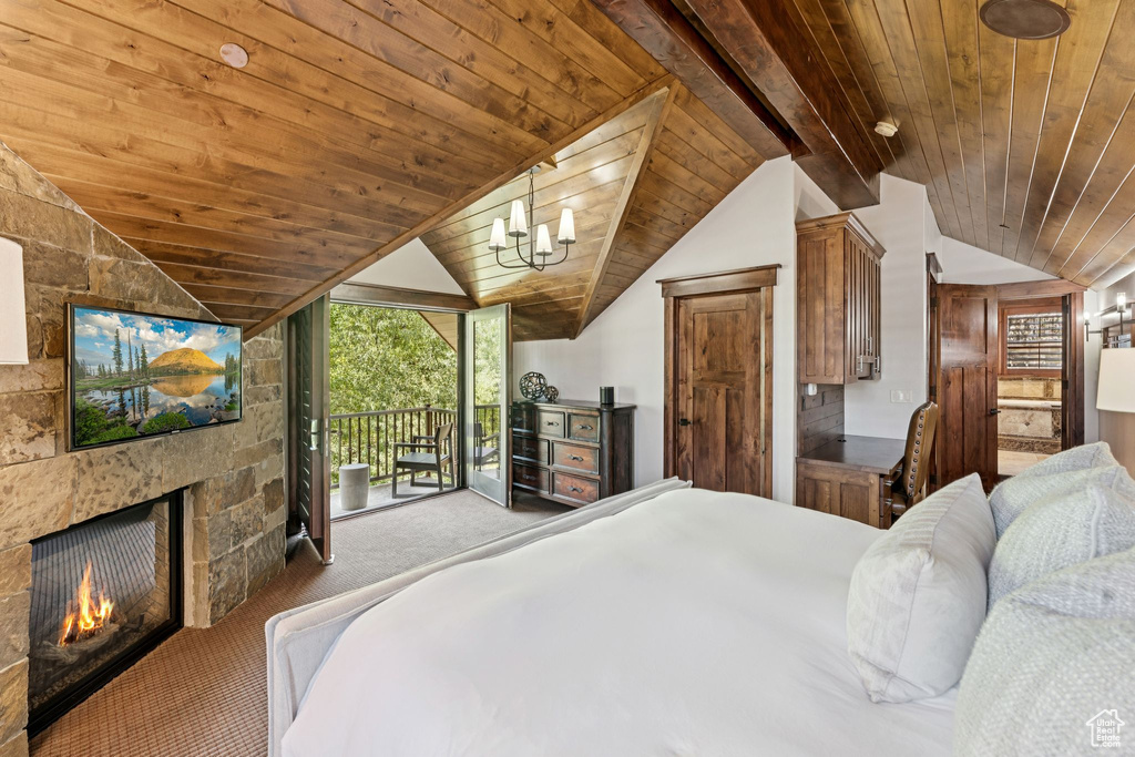 Carpeted bedroom with access to outside, wood ceiling, a fireplace, and a chandelier