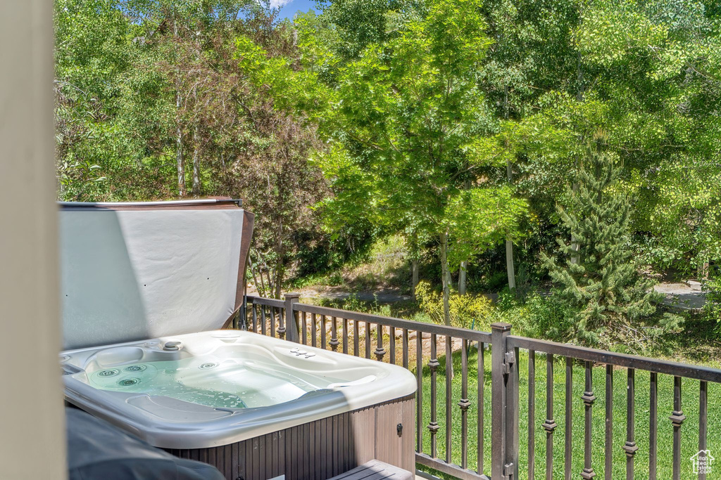Deck with a hot tub and grilling area