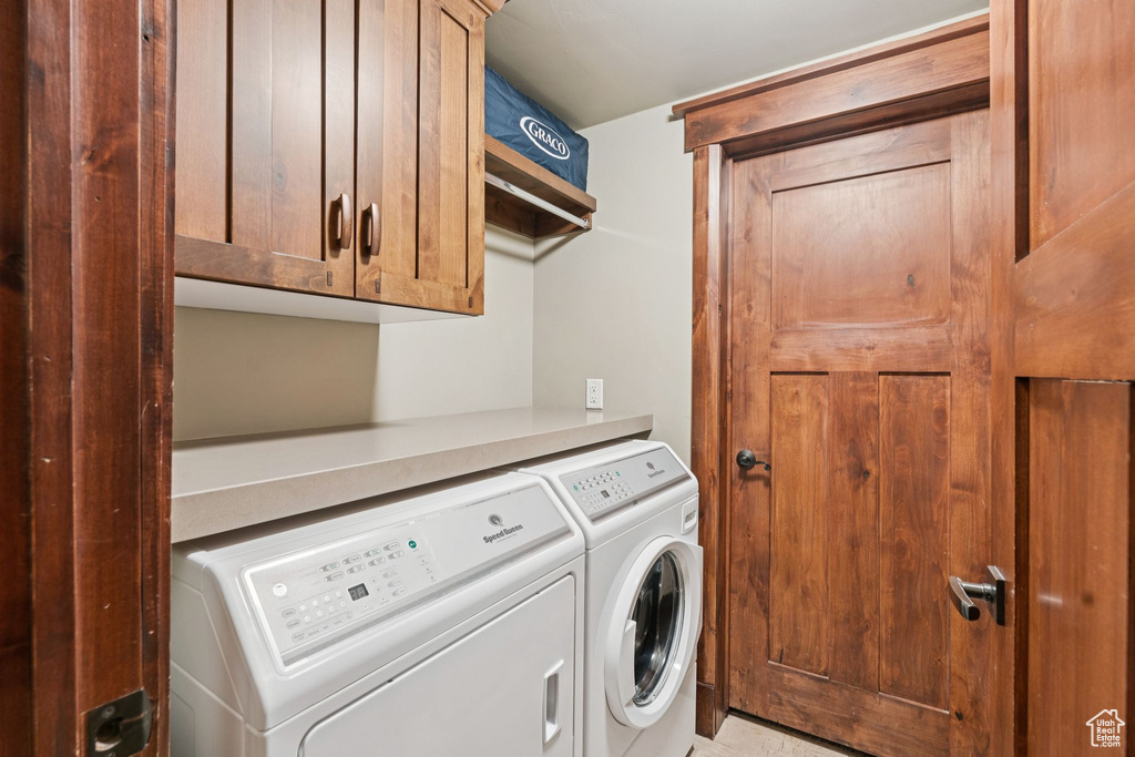Laundry room with cabinet space and separate washer and dryer