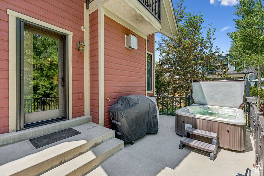 View of patio / terrace with a hot tub and area for grilling