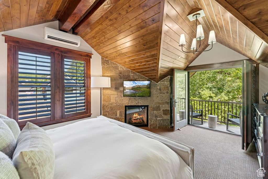 Bedroom featuring a wall mounted AC, access to outside, carpet flooring, a fireplace, and wood ceiling