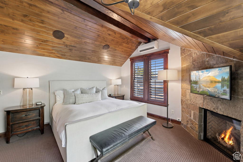 Bedroom featuring carpet floors, an AC wall unit, wood ceiling, and a lit fireplace