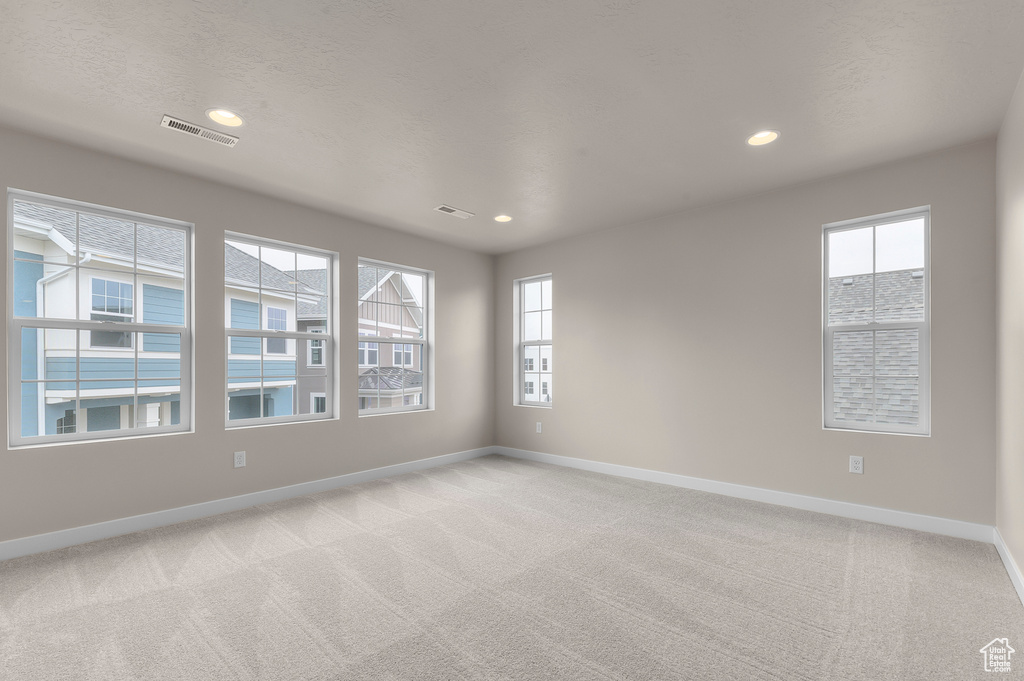 Spare room with light colored carpet and recessed lighting