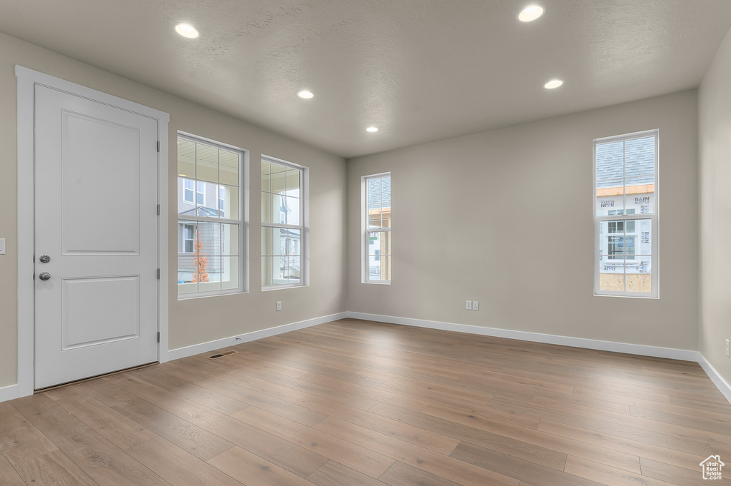 Empty room with recessed lighting and light wood-type flooring