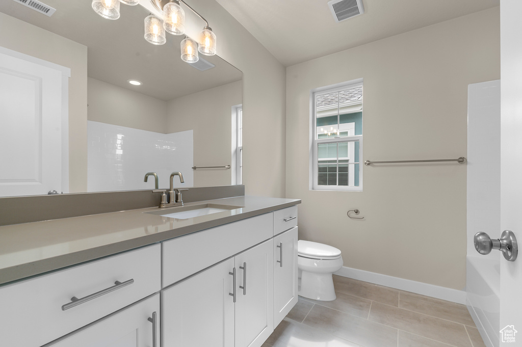 Bathroom with vanity, tile patterned floors, shower / tub combination, and recessed lighting