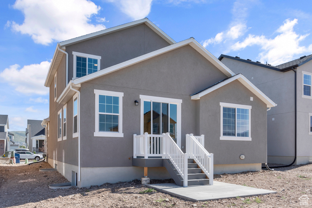 Rear view of house featuring stucco siding
