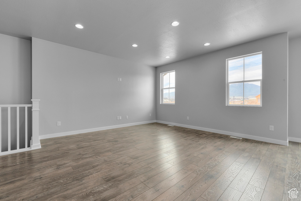 Unfurnished room featuring dark wood-style floors and recessed lighting
