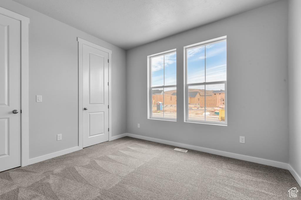 Unfurnished bedroom with carpet floors