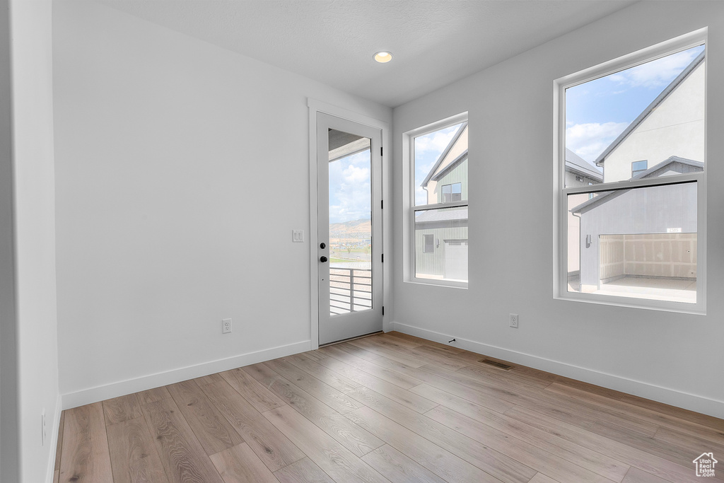 Unfurnished room featuring baseboards and light wood-style flooring