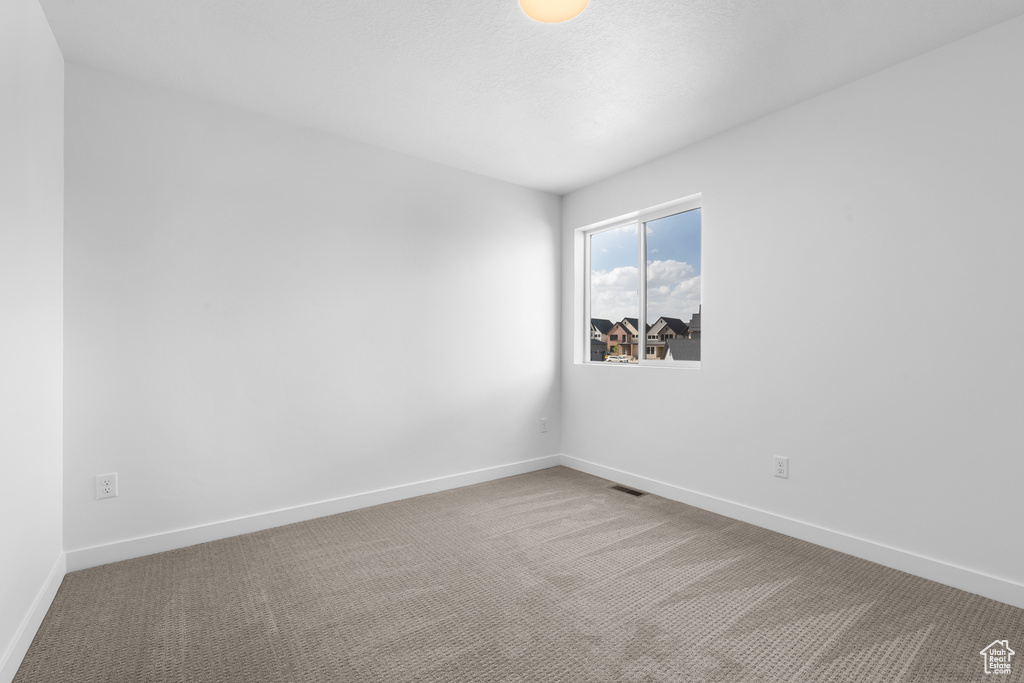 Unfurnished room with carpet