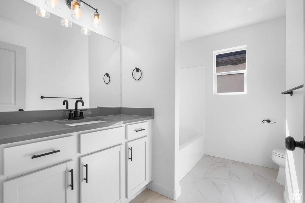 Bathroom with vanity and marble finish floors