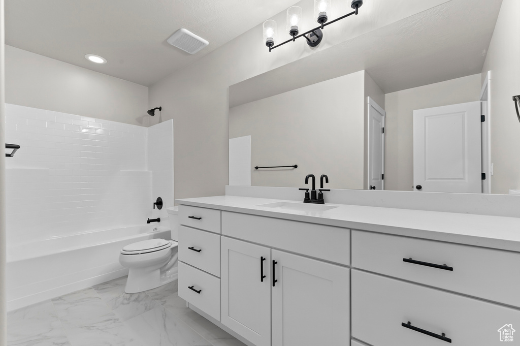 Full bath with vanity,  shower combination, marble finish flooring, and recessed lighting
