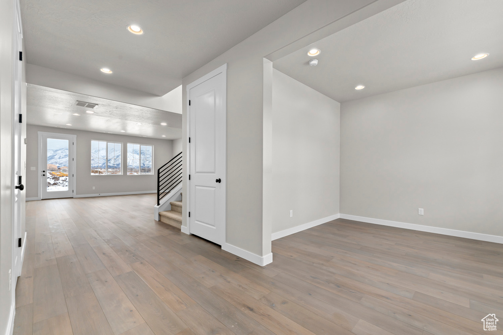 Spare room featuring stairway, recessed lighting, and light wood-style floors