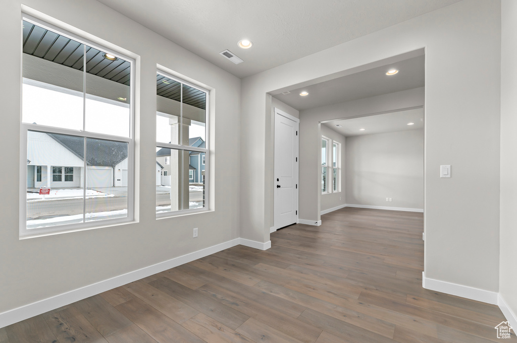 Unfurnished room with wood finished floors and recessed lighting