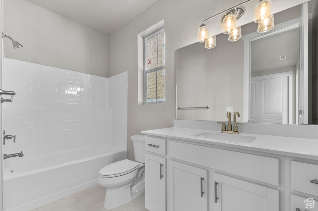 Bathroom with vanity, shower / bathtub combination, and tile patterned floors