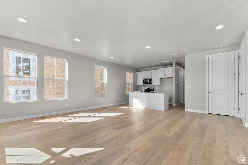 Unfurnished living room featuring recessed lighting and light wood finished floors