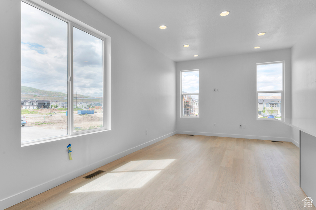 Empty room with recessed lighting and light wood-style flooring