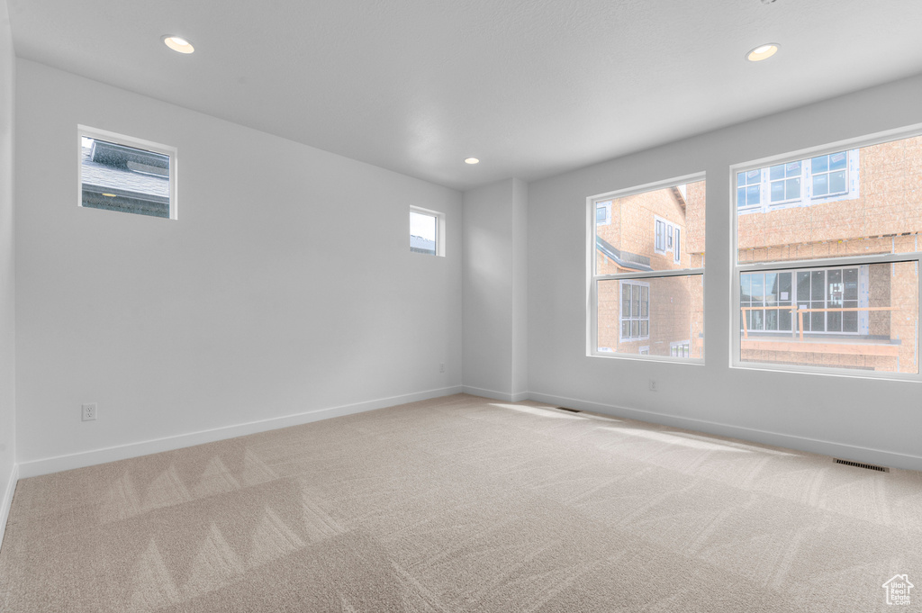 Spare room with light colored carpet and recessed lighting