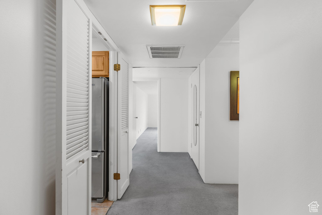 Hall featuring light carpet