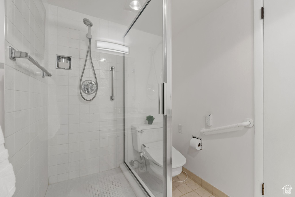 Full bathroom with a shower stall and tile patterned flooring