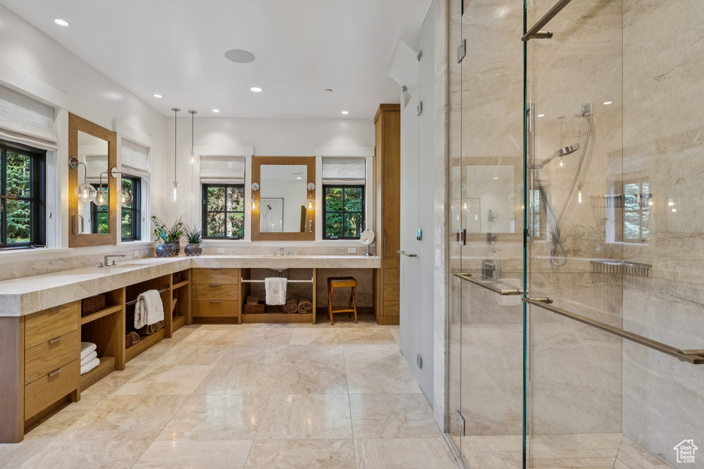 Bathroom with double vanity, a stall shower, recessed lighting, and marble finish flooring