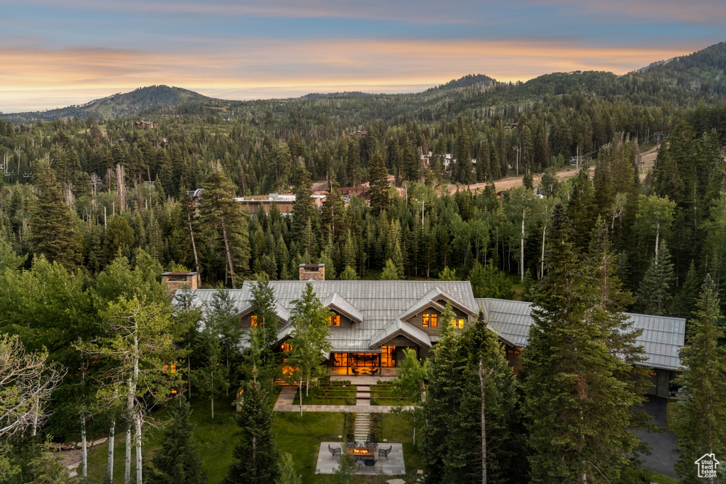 View of mountain backdrop featuring a heavily wooded area