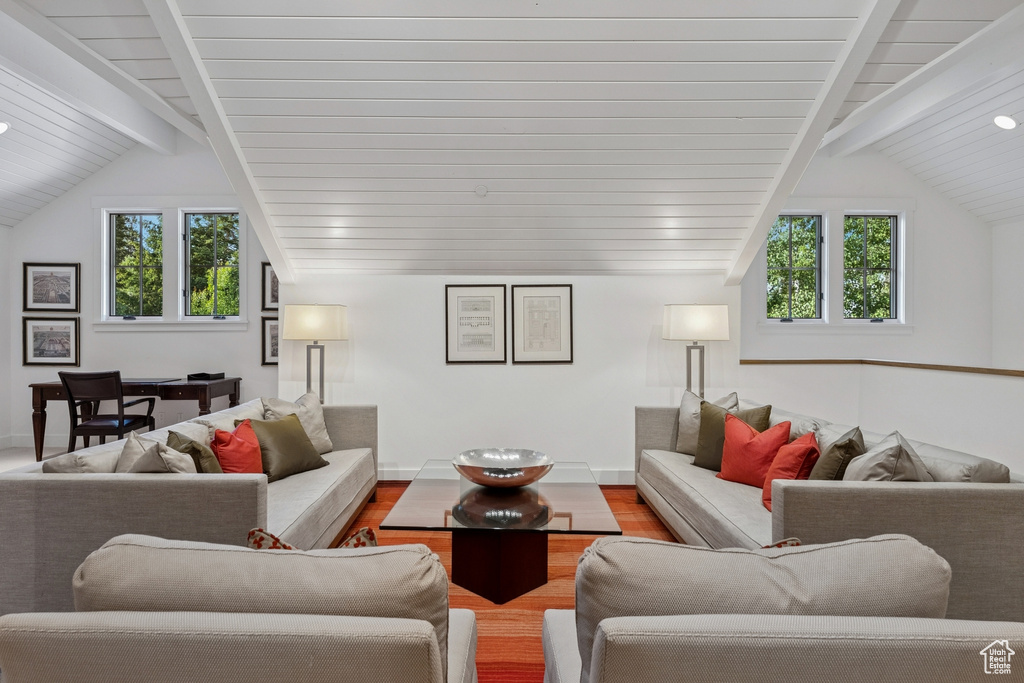 Living area with healthy amount of natural light, wood finished floors, and wooden ceiling