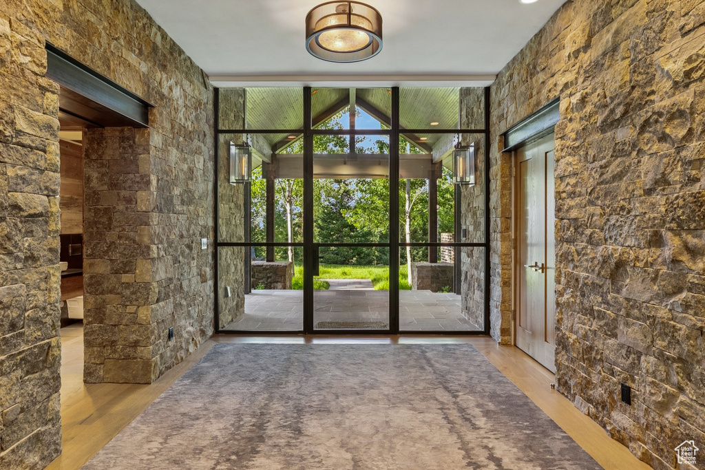 Entryway featuring a wall of windows and wood finished floors