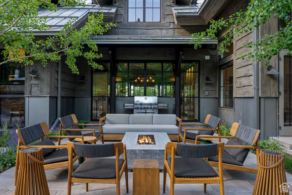 View of patio / terrace with an outdoor living space with a fire pit and a grill