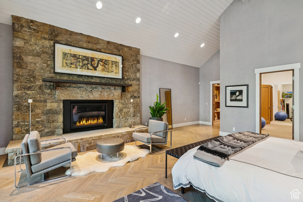 Bedroom with high vaulted ceiling, wood ceiling, a fireplace, and recessed lighting