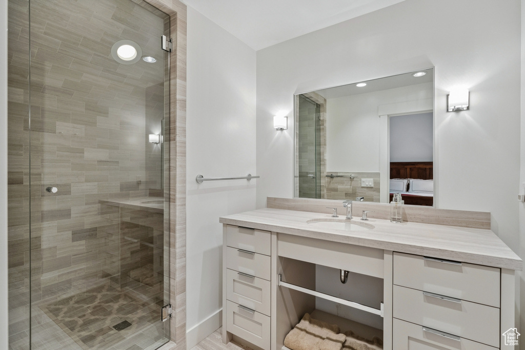 Ensuite bathroom featuring vanity and a shower stall