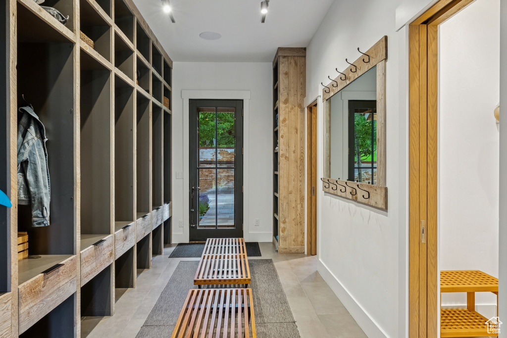 Mudroom with baseboards and light tile patterned floors