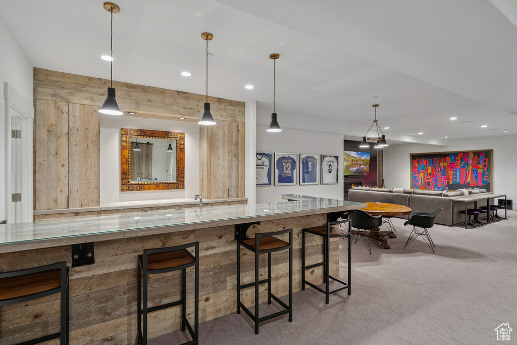 Bar area with recessed lighting, carpet, and pendant lighting