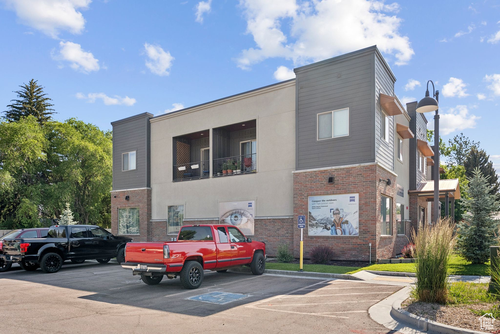View of property with uncovered parking