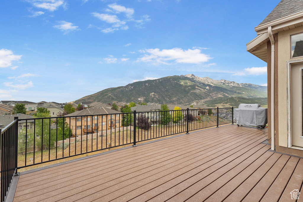Wooden terrace featuring a mountain view and a residential view