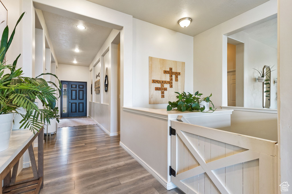 Hall with wood finished floors and baseboards