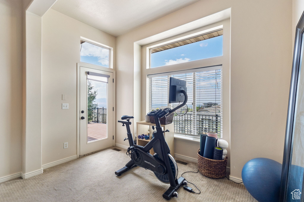 Workout room with carpet and baseboards