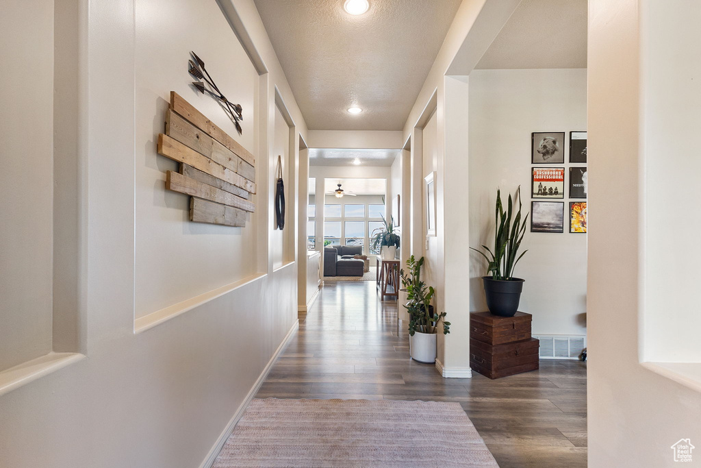 Corridor featuring dark wood-style floors and recessed lighting