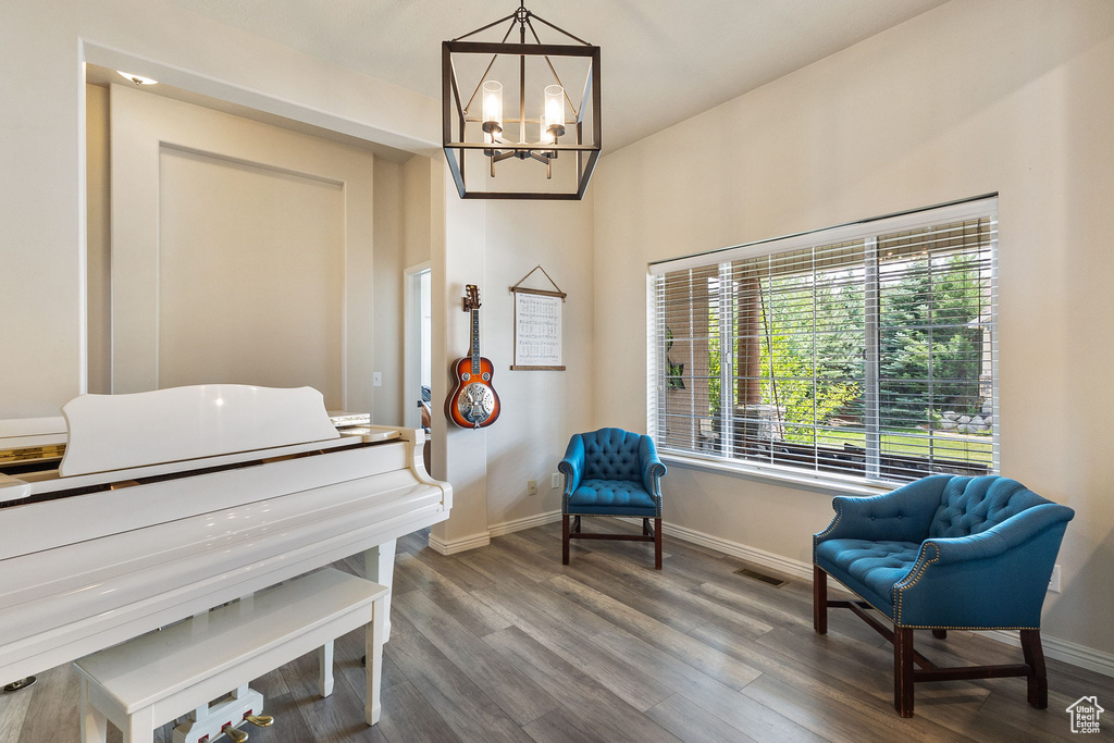 Living area featuring a chandelier and wood finished floors