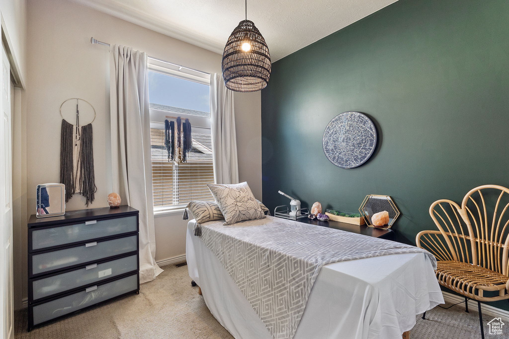 Carpeted bedroom featuring baseboards