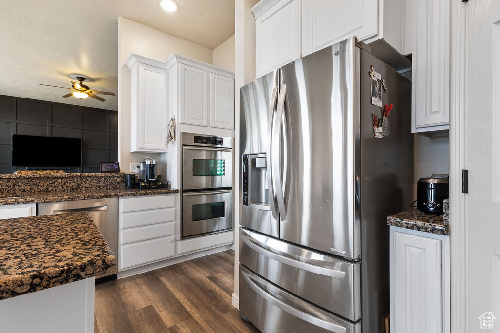 Kitchen featuring appliances with stainless steel finishes, ceiling fan, dark wood finished floors, white cabinets, and recessed lighting