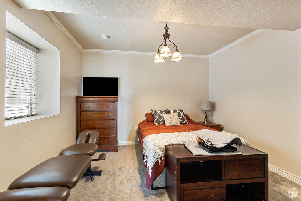 Bedroom featuring light colored carpet, ornamental molding, and a chandelier