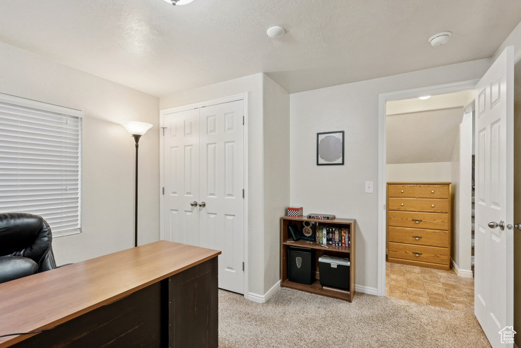 Office with light carpet and baseboards