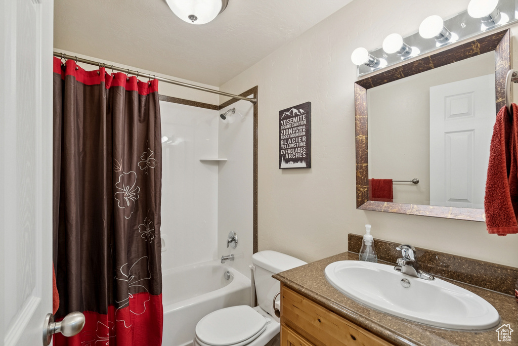 Full bathroom featuring vanity and shower / bath combo with shower curtain