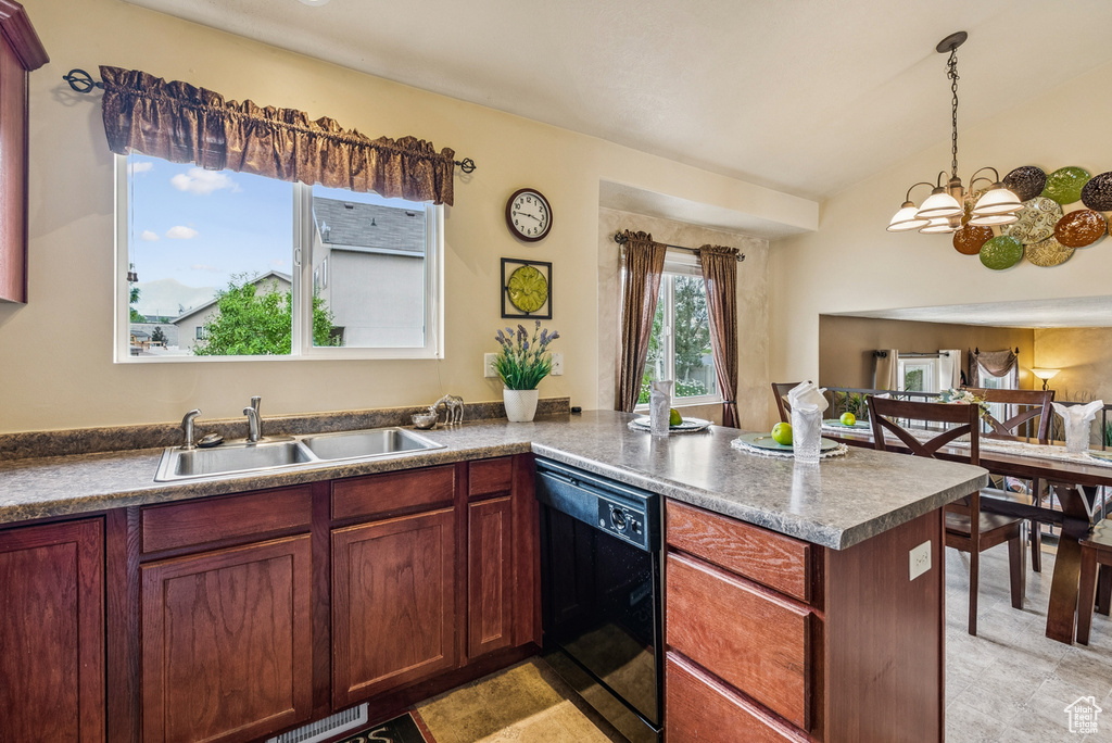 Kitchen with black dishwasher, a peninsula, a chandelier, pendant lighting, and vaulted ceiling