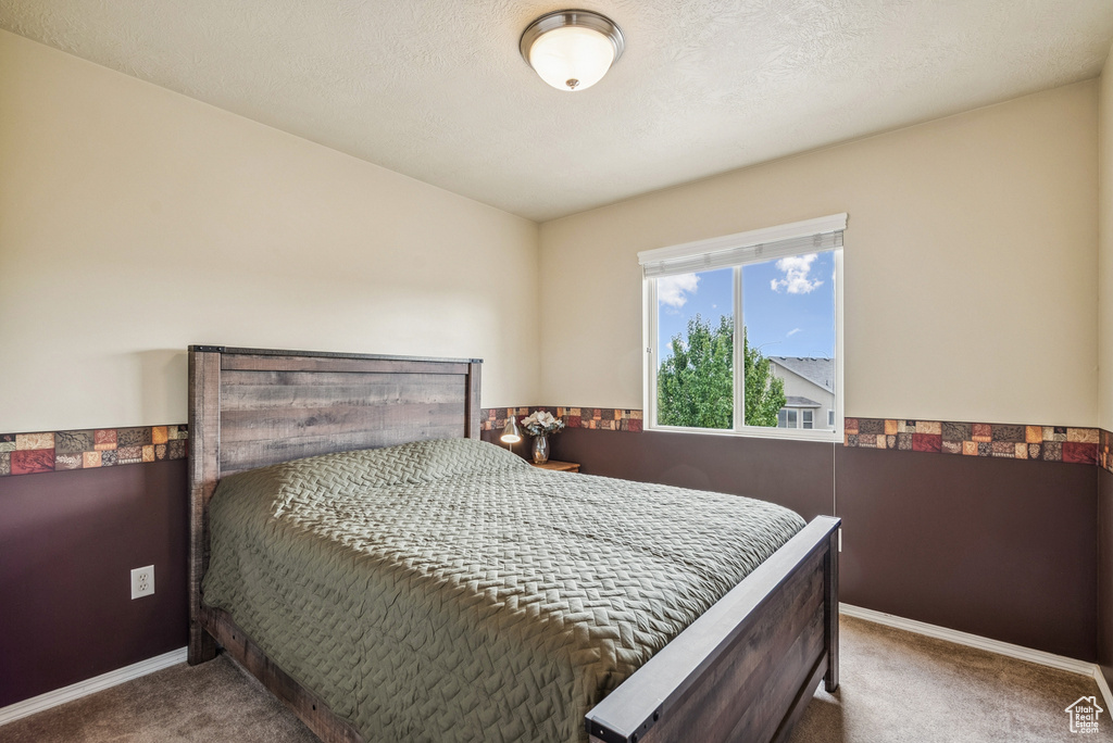 Carpeted bedroom with baseboards