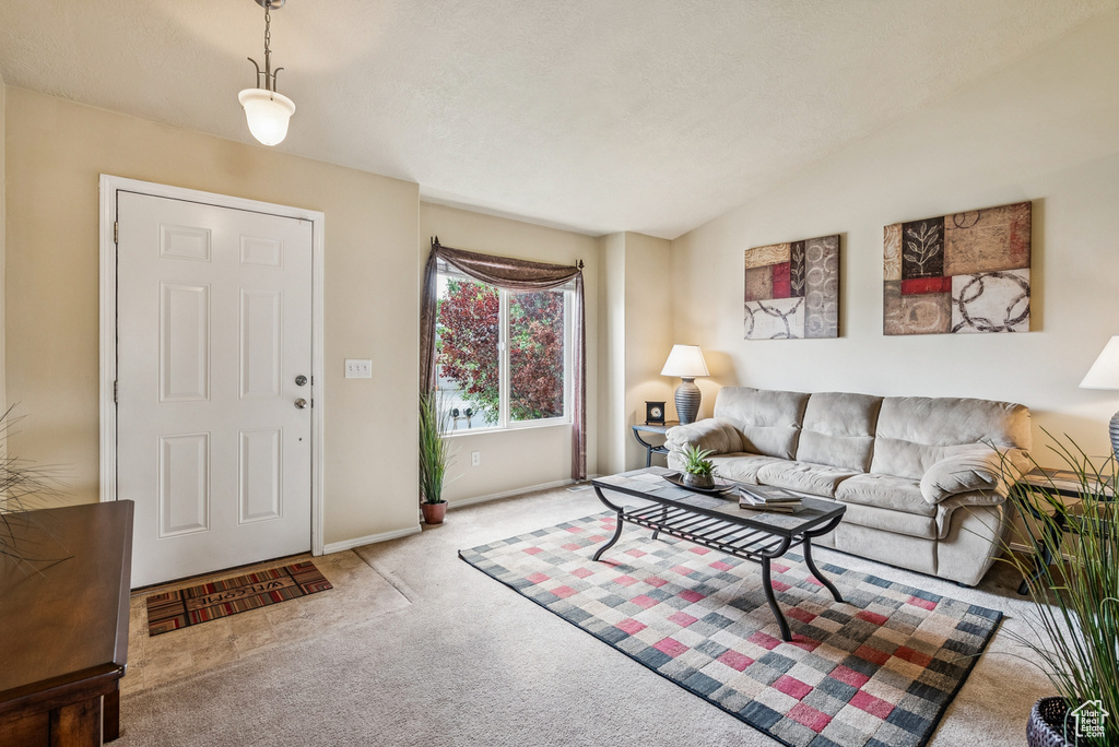 Living area with carpet flooring and baseboards